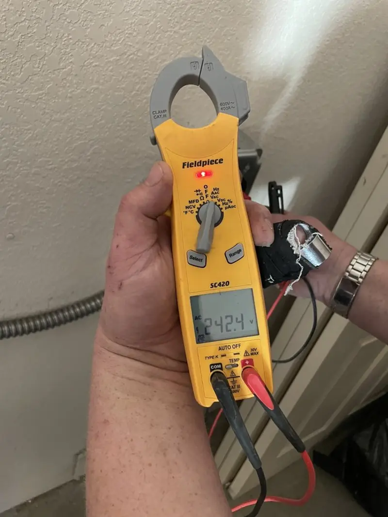 Voltage testing with clamp meter during Recessed Lighting Installation in Blythewood